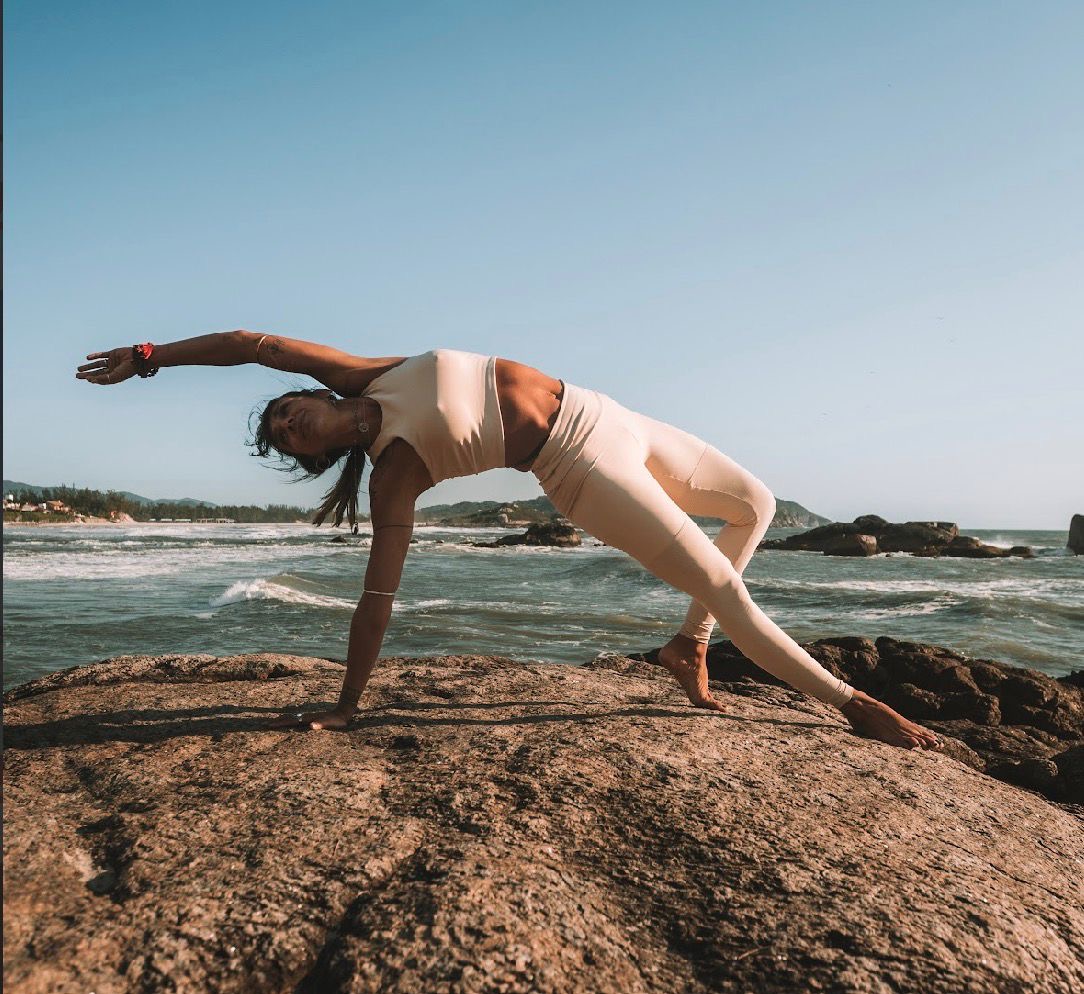Prática de yoga na praia ao amanhecer